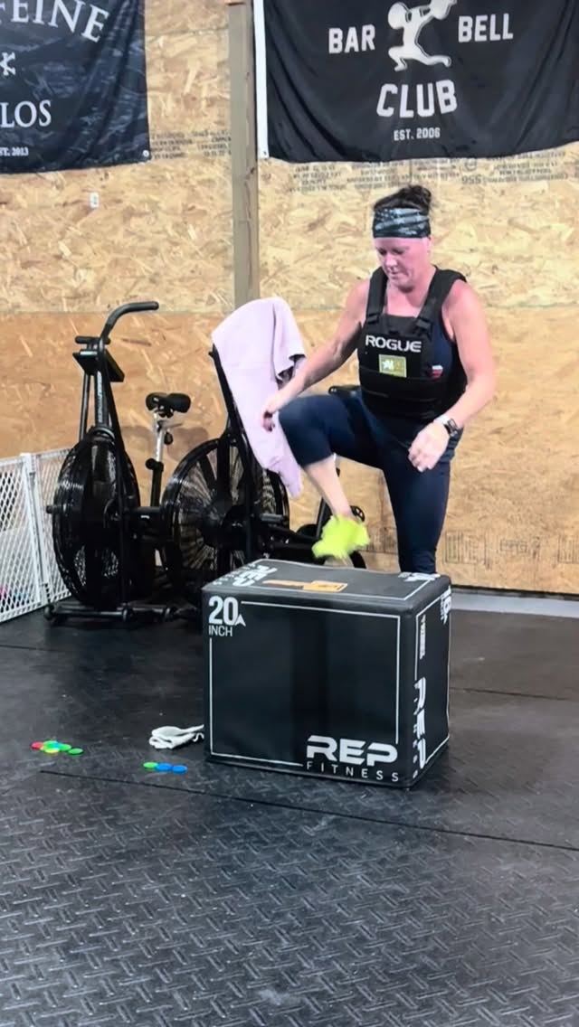 Member stepping to a box wearing a weight vest