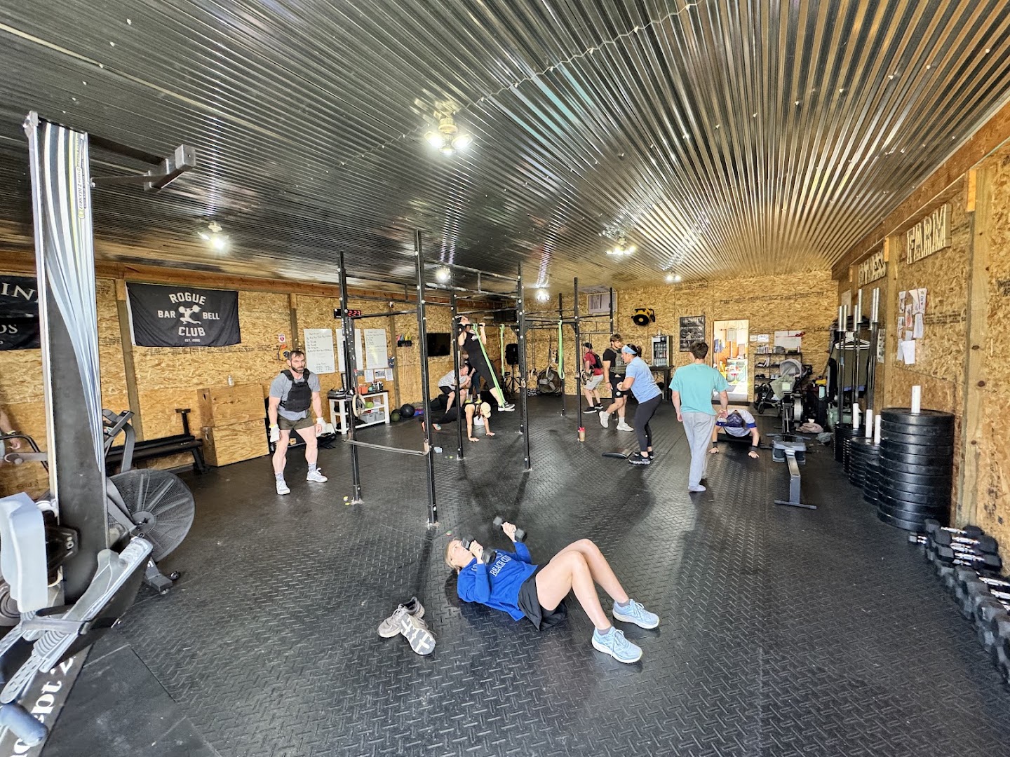 A full class training in the barn, a dozen members working through a workout