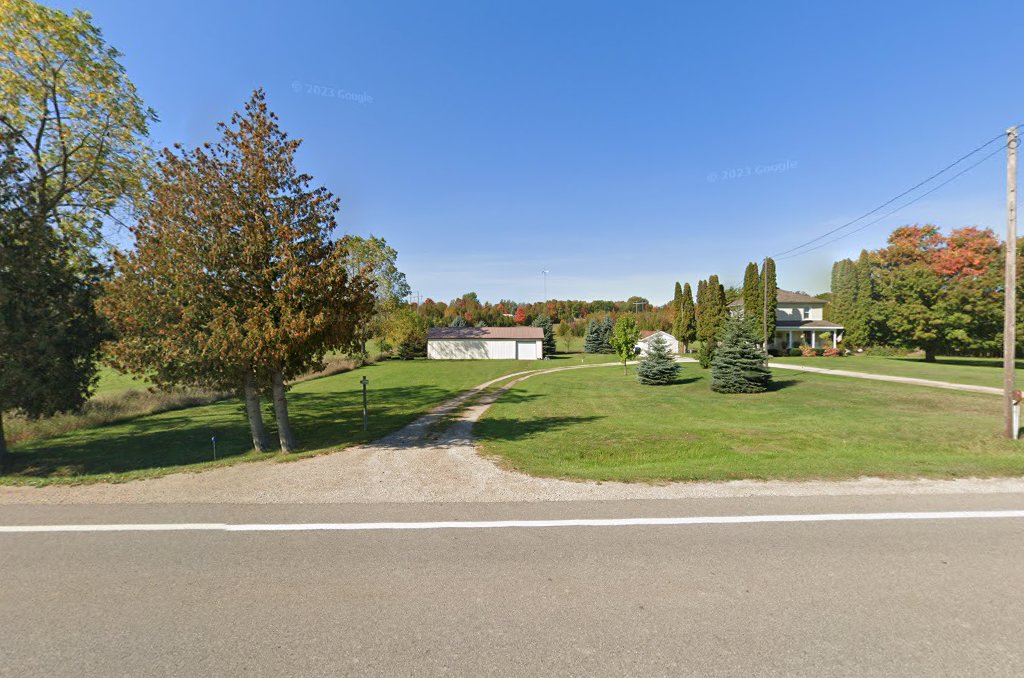 View of the property from Marion Center Road: gravel drive, lawn, barn and farmhouse